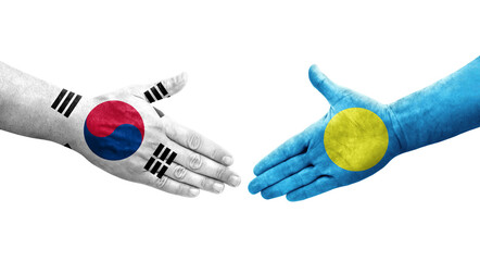 Handshake between South Korea and Palau flags painted on hands, isolated transparent image.
