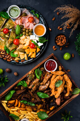 Set to wine and beer cheese bread with pesto, pork, assorted cheeses, capers