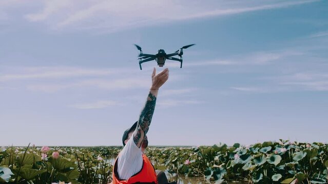 Man catches and lands drone with bare hands. Slow motion. High quality 4k footage	