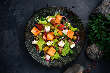 Greek salad feta cheese, croutons, lettuce, olives, onion and olive oil.