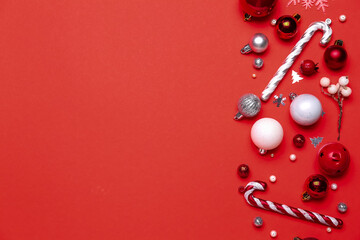 Composition with different Christmas decorations on red background