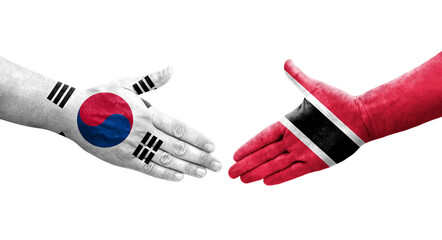 Handshake between South Korea and Trinidad Tobago flags painted on hands, isolated transparent image.