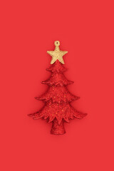 Christmas tree bauble glitter decoration on red background. Traditional retro ornament symbol for the festive Xmas season.