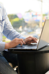 man sitting on laptop keyboard