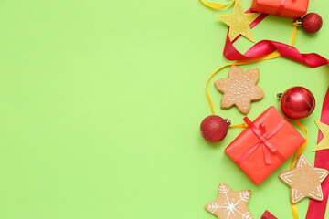 Composition with Christmas balls, gifts, cookies and ribbons on green background