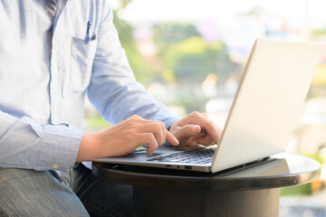 man sitting on laptop keyboard