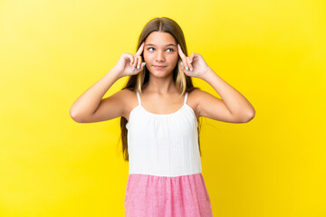 Fototapeta na wymiar Little caucasian girl isolated on yellow background having doubts and thinking