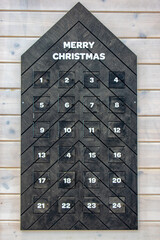 Decorative wooden advent calendar fixed on the wall
