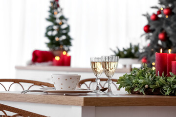Christmas table setting with glasses of champagne in kitchen, closeup