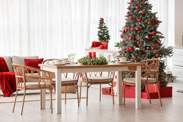 Interior of kitchen with Christmas trees and dining table