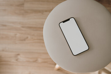 Flatlay mobile phone on grey stool