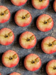 Apple pattern on black concrete background. Red apple with green leaf on black table.