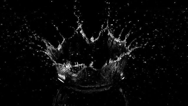 Super slow motion of splashing water crown shape on black background. Filmed on high speed cinema camera, 1000fps.