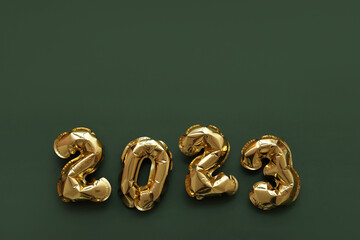 Figure 2023 made of foil balloons on color background