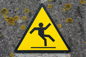 Sign beware slippery floor on a wall