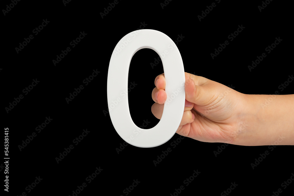 Aufkleber Zero in hand. The number zero is clasped in a hand isolated on a black background. Number zero white in a child's hand on a black background.