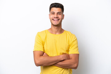 Young caucasian man isolated on white background keeping the arms crossed in frontal position