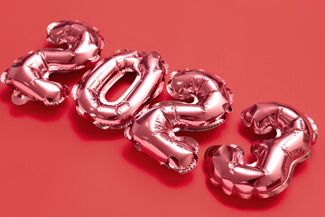 Figure 2023 made of balloons on red background, closeup