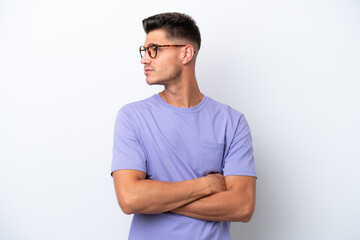 Fototapeta premium Young caucasian man isolated on white background keeping the arms crossed