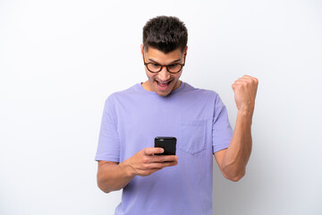 Young caucasian man isolated on white background surprised and sending a message