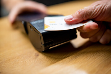 Close up of credit card in hand contactless payment