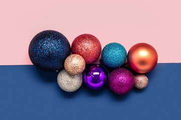 Set of different Christmas balls on color background