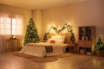 Fototapeta na wymiar Interior of bedroom with glowing Christmas trees and fir branches