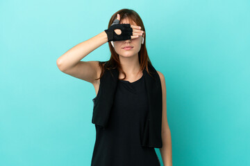 Redhead sport girl isolated on blue background covering eyes by hands. Do not want to see something