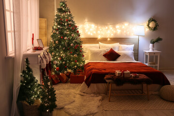 Interior of bedroom with glowing lights and Christmas trees