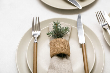 Beautiful table setting with Christmas branches on white background, closeup