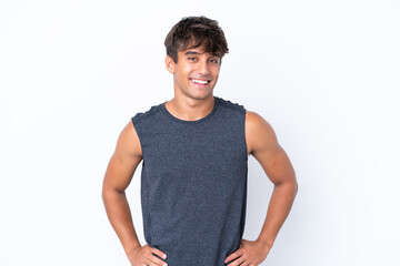 Fototapeta premium Young sport caucasian man isolated on white background posing with arms at hip and smiling