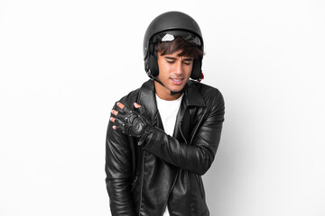 Young man with a motorcycle helmet isolated on white background suffering from pain in shoulder for having made an effort