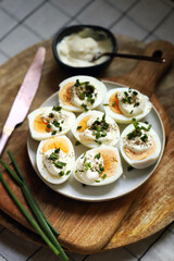 Boiled egg halves with mayonnaise and green onions.
