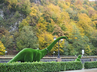 A dinosaur created from bushes. Topiary trees