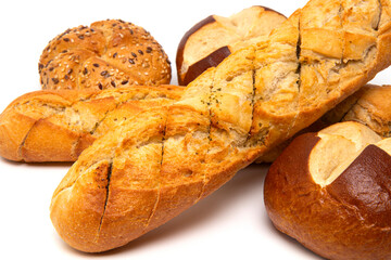 Bakery product assortment Fresh crispy French bread baguette, kaiser roll bun with linseeds and sesame, traditional German laugenbrot, Bavarian pretzel rolls lye bread isolated on a white background