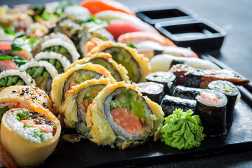 Fresh and colorful sushi set made of avocado and salmon.