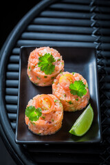 Tasty and healthy salmon tartare with cherry tomatoes and lime.