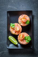 Delicious and soute salmon tartare with cherry tomatoes and lime.