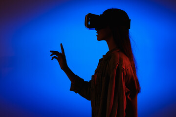 VR virtual reality glasses on a girl. Looks to the future. Touching the new. Fantastic virtual...