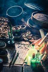 Magical alchemist lab with recipe and old scrolls.