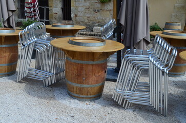 Tonneaux et Chaises empilées sur la terrasse d'un restaurant. (France)