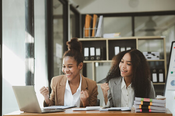 Two American women are working together in the office of a startup company. They are having a brainstorming and planning meeting in a joint department, women leading the way. Concept of women's work.