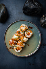 Sushi rolls with shrimp, Philadelphia cheese, avocado, cashews, teriyaki sauce with caramel.