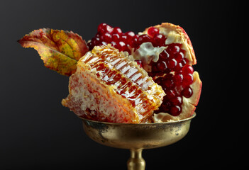  Honeycomb and pomegranate in an old brass dish.
