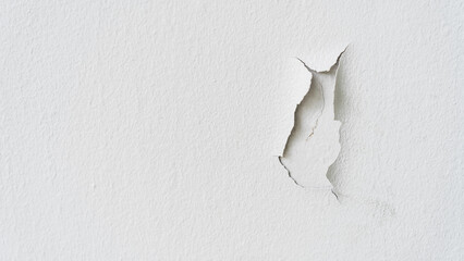 Old white color paint wall background cracked, Broken rough cement surface vintage style and unqualified