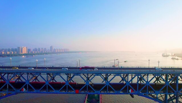 Early morning aerial view of trains driving on Nanjing Yangtze River Bridge in Jiangsu, China