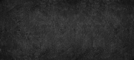 Black rough concrete wall widescreen texture. Dark abstract textured background