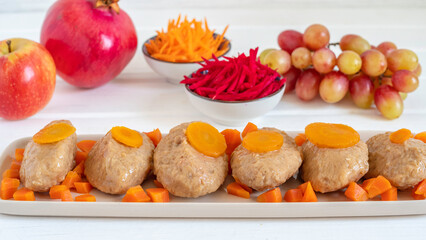  Traditional Gefilte fish for Jewish holiday Rosh Hashanah on the background of fresh fruits and vegetables.