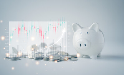 Piggy bank and coins on the table. Holographic financial graph on the left side . Concepts of finance, investment and banking, savings, returns, value and interest rates.