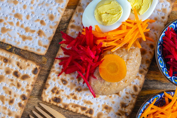 Traditional food gefilte fish, vegetables, matzah, egg for Jewish holiday Pesach (Passover).